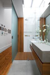 Bathed in Light

To help disperse light in the newly opened-up interior, the designers clad the roof over the guest bathroom with Danpalon, a translucent polycarbonate that brings in lots of softened natural light. The walls and door are frosted glass. Says Kyprianou: “You can’t see much through the glass—just silhouettes—so our guests don’t mind!”

danpalon.com.au

Hung Up

With the budget running out toward the end of the project, Kyprianou wanted to avoid forking out for a custom-designed walk-in closet in the master bedroom. So he conceived of a simple and cheap storage solution: drilling holes through the wooden roof trusses and feeding inexpensive aluminum closet rods through.

junolightinggroup.com