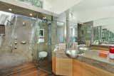 In the bathroom, generous windows and skylights create the illusion of an outdoor shower. 