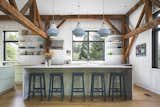 Inside, rustic elements (like wood beams and whitewashed wood) nod to the structure’s former life, while walls of glass, black metal accents, and sleek furnishings give it a fresh, new look. After the renovation, the couple loved the guesthouse so much they decided to make it their full-time dwelling.