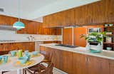 The charming kitchen retains its original walnut cabinets.

