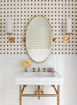 The renovation of a 1925 residence for a growing family included the demolition of a powder room and the design of a new half bathroom on the ground floor of the Colonial Revival home.