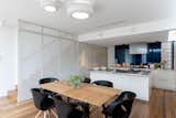 The kitchen was designed to work best for the professional chef with a stainless-steel kitchen island, exposed decorative hood, and plentiful storage concealed behind operable perforated screens.