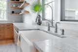 A gray marble counter adds texture and visual interest to this kitchen designed by Jesse Vickers. 