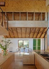 Simpson retained the original roof trusses and left them exposed as a reminder of the building's industrial heritage. The etched panels recycled from Anderson's former art installation line the ceiling above the trusses.