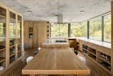 A band of windows wraps around the kitchen to bring the outdoors into the kitchen, which is outfitted with Piacere equipment.