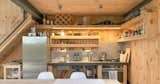 Pallets, packing fillets, and cross-laminated timber factory offcuts were repurposed as joinery fittings, including the doors, cupboards and countertops in the kitchen.
