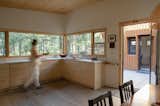 Early in the design process, Diane had considered a dropped ceiling over the kitchen to distinguish it from the living/dining area. “Our builder Trevor said he liked the feel of the interior space and advised against it,” reveals Diane. “We’re so glad he did!” He also made other small suggestions, including the stepped trim around the door frames. A piece of the original boxcar was salvaged by Diane’s son and daughter-in-law and turned into a key rack hanging by the main door.
