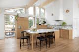 By far the biggest transformation, the new kitchen enjoys high ceilings from the revamped roofline; all new casework, flooring, and finishes; and a large island. The stools are from 2xhome.